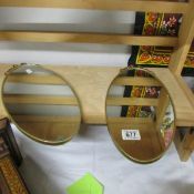 A pair of oval wall mirrors.