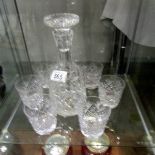 A cut glass decanter and 6 glasses.