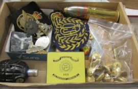 A tray of military memorabilia including buttons and badges.