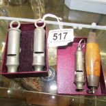3 vintage whistles & a knife in a barrel holder.