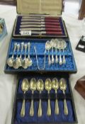 A cased set of 6 butter knives and 2 cased sets of teaspoons.