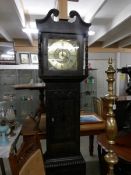 A carved oak cased Grandfather clock with brass dial.