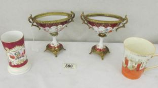 A pair of continental porcelain urns (one a/f), a Cinderalla mug and a vase.