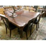 A Victorian mahogany dining table and 4 chairs.