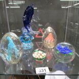 5 glass paperweights including a dolphin.