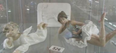 A signed Lladro Collector's society piece, a Lladro cherub and a NAO ballerina.