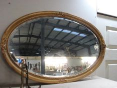 An oval bevel edged mirror