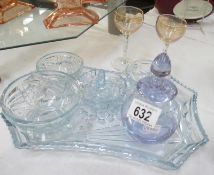 A clear blue glass vanity set
