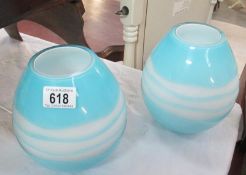 A pair of blue and white glass bowls / vases