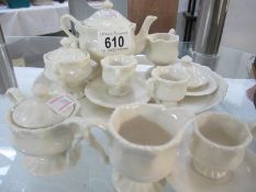 A white miniature tea set including milk and sugar