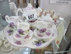 A miniature floral patterned tea set