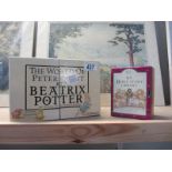 A boxed set of The World of Beatrix Potter books etc