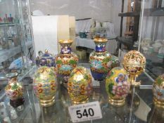 A collection of cloisonne eggs and small vases