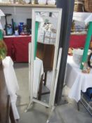 A floor standing dressing mirror