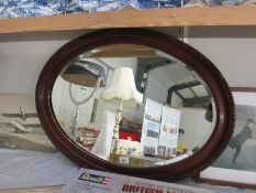 A wooden framed oval mirror