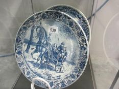 Two blue and white chargers featuring winter scenes - Delft Blauw