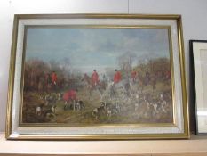 A large framed hunting print showing riders and hounds