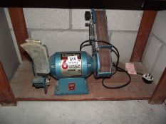 A Clarke 6" bench grinder with sanding belt.