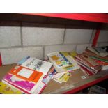 A shelf of old maps and workshop manuals.