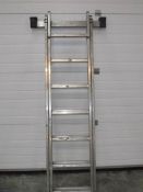 A galvanised aluminium double extending ladder.
