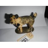 A painted bronze car mascot of a dog.