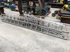 A quantity of wood and aluminium ladders.