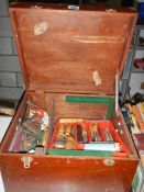 A wooden box of tools including wood chisels, plane, clamps etc.