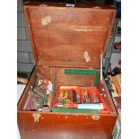 A wooden box of tools including wood chisels, plane, clamps etc.