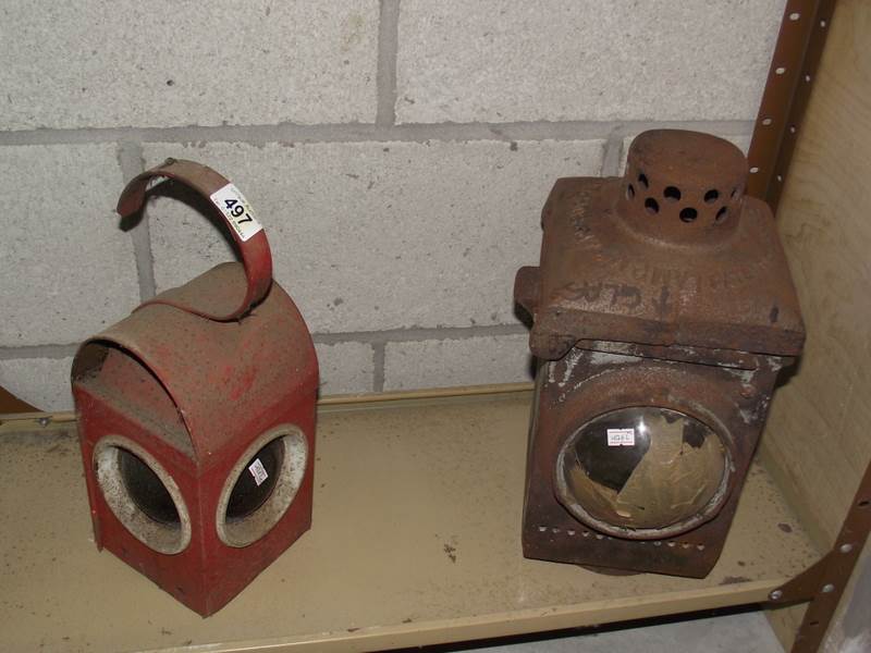 A cast iron railway lamp and a vintage road works lamp.