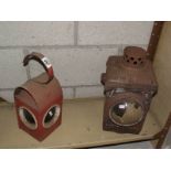 A cast iron railway lamp and a vintage road works lamp.