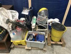 A pallett of miscellaneous items including safety equipment, drain rods, ratchet strap,