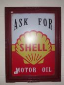 A retro 'Ask for Shell Motor Oil' sign in an old frame.