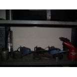 A collection of oil cans, blow gun. fire extinguisher etc.