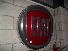 A large plastic Fiat main dealer light up sign.