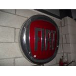 A large plastic Fiat main dealer light up sign.