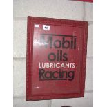 A retro Mobil Oils Lubricating Racing metal sign in old wooden frame.