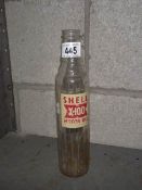 A Shell X-100 motor oil glass bottle.