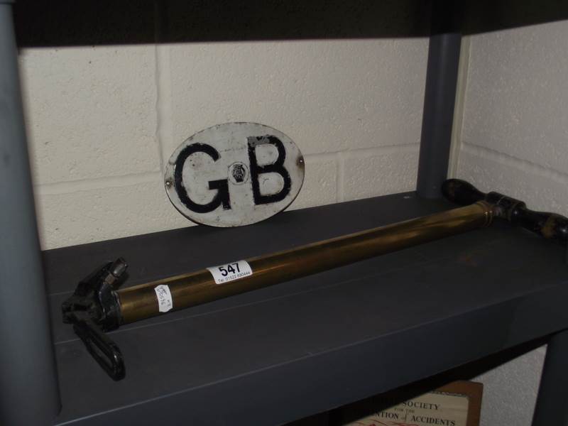 A GB AA plaque and a brass King Dick stirrup tyre pump.