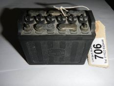 A vintage model of an Exide battery match holder.