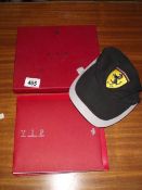 A Ferrari VIP vehicle identification passport and a licensed product baseball cap.