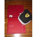 A Ferrari VIP vehicle identification passport and a licensed product baseball cap.