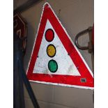 A metal traffic light warning triangle metal road sign.