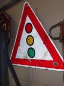 A metal traffic light warning triangle metal road sign.