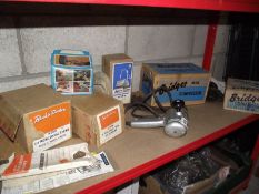 A vintage Black & Decker drill with boxed attachments including Bridges compressor and spray gun.