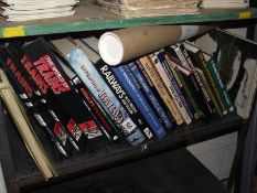 A shelf of books on railways including posters.