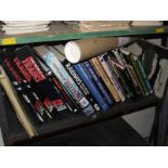 A shelf of books on railways including posters.