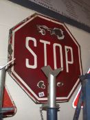 An enamel 'Stop' road sign.