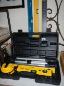 A boxed Power Master laser level etc., including set squares and spirit level.