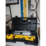 A boxed Power Master laser level etc., including set squares and spirit level.