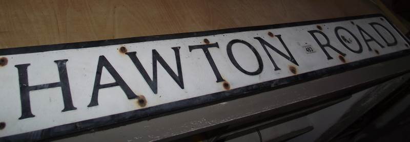 A pressed aluminium 'Hawton Road' street sign.